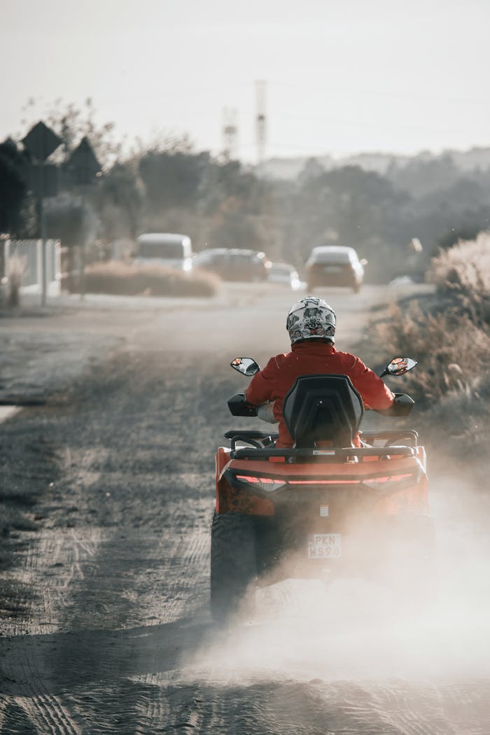 A thrilling quad bike ride on a dusty road surrounded by nature in Rudzica, Poland.